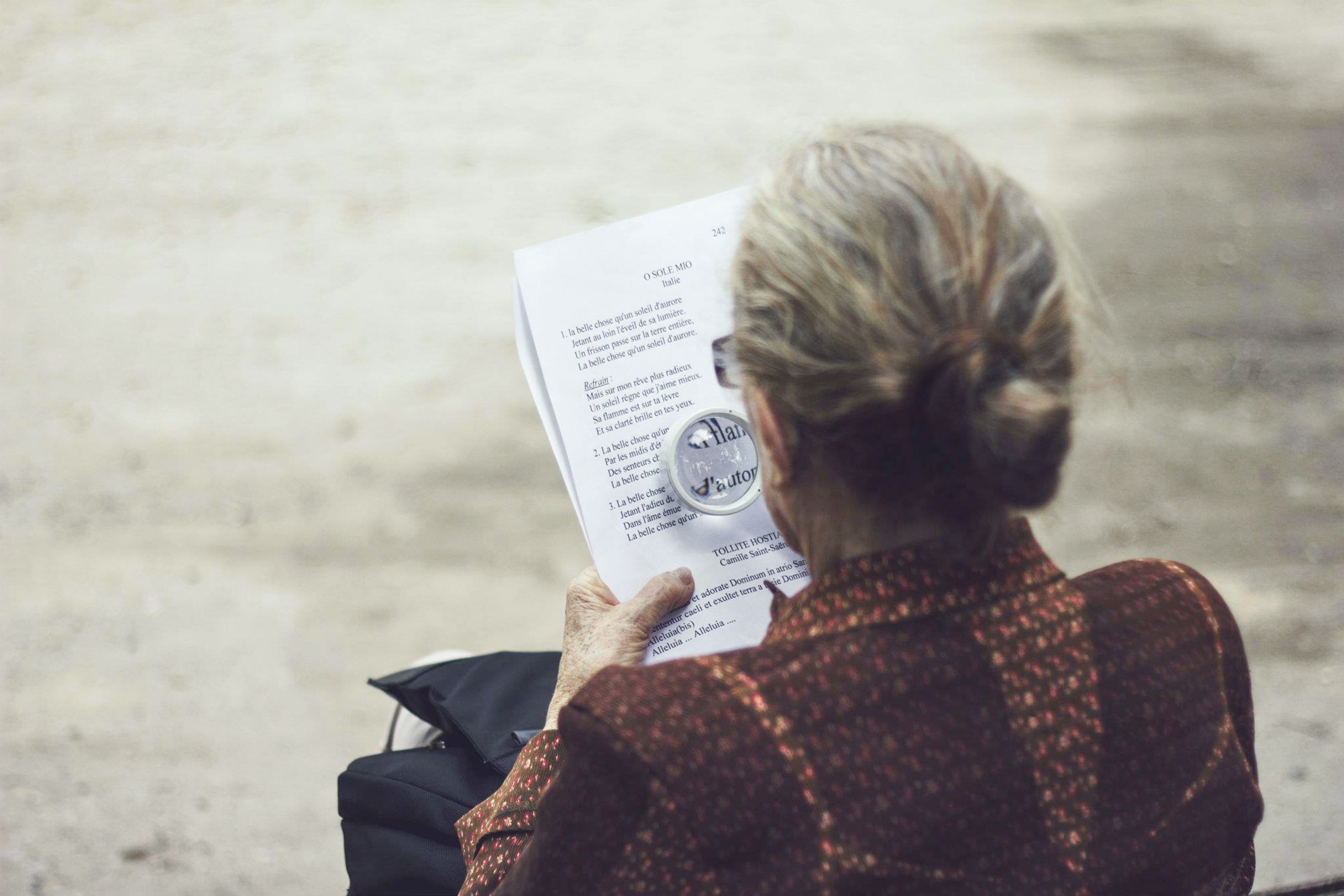 Lady using magnifier to